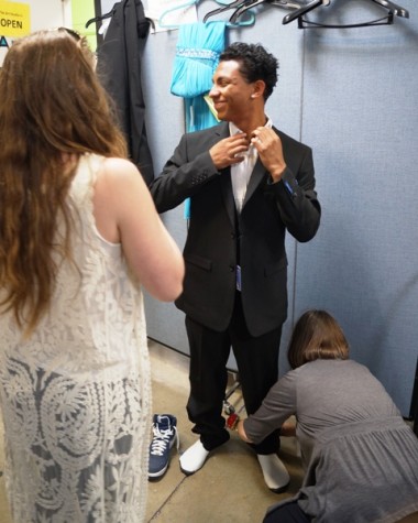 APCH teens try on suits and dresses from the annual Cinderella and Prince Charming Project. Photographer: Grace Rector '17.