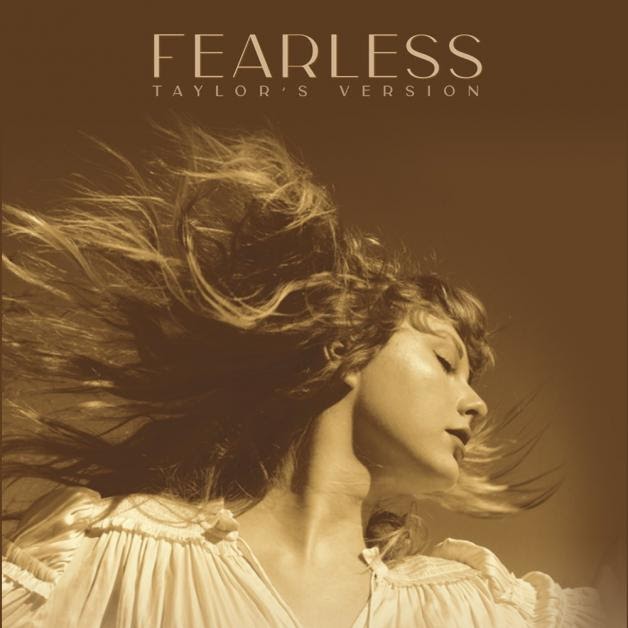 An adult Taylor recreating her 2008 album cover with the similar golden vibe emanating from the photo (https://www.clashmusic.com/reviews/taylor-swift-fearless-taylors-version). 