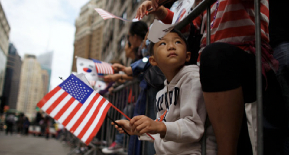 Picture of a Korean American child holding an American flag that symbolizes the third wave of Korean immigrants that we live through today. Sourced from Boston University’s Boston Korean Diaspora Project (https://sites.bu.edu/koreandiaspora/issues/history-of-korean-immigration-to-america-from-1903-to-present/)