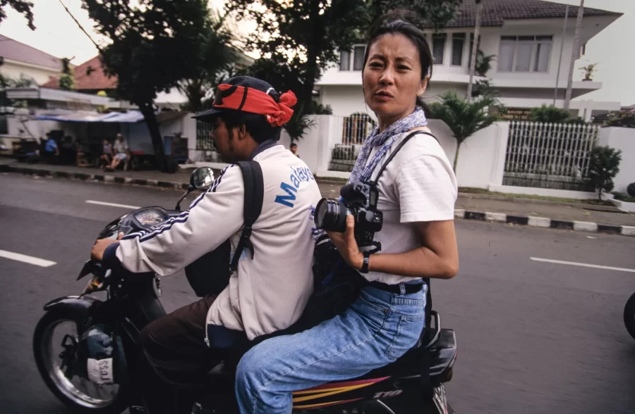 Photojournalist Yunghi Kim getting around students protests in Indonesia 1998. Photo by Paula Bronstein.